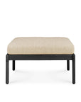The Ethnicraft Jack Outdoor Footstool features a light beige cushioned top and a black teak frame, shown against a plain white background.