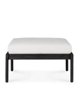 The Jack Outdoor Footstool by Ethnicraft features a thick off-white cushion and a sleek black teak frame, shown against a plain white background.