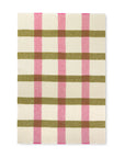The Elvang Denmark Lava Throw - Pink features an off-white background with a plaid pattern of olive green and pink stripes, inspired by Scandinavian blankets and creating a grid with alternating colors.