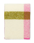 The Elvang Denmark Lava Throw - Pink, featuring a soft bouclé texture with a wide olive green horizontal stripe and a pink vertical stripe near one edge, is displayed folded on a white background.