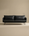 The SOBU Cherry Sofa | Leather, a modern black 3-seater with slim arms and metal legs, brings Danish-inspired style to any living space, shown centered against a plain beige background.