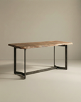 The Moes Leviathan Live Edge Counter Table features a rectangular solid acacia top and a sculptural metal base, displayed against a plain, neutral background.