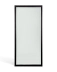 The Ethnicraft Light Frame Floor Mirror - Black features a tall, full-length design with a simple black-stained oak frame, shown upright against a plain white background.