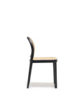 The Luk Dining Chair by Wooden Stories features a wooden frame with a cane weave rattan seat and backrest, shown in a simple side view against a plain white background.