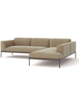 The Wooden Stories Department Modular Sofa | Fabric • M6 features light brown upholstery, a low backrest, and slim black metal legs in a modern Danish-inspired L-shaped design, shown on a plain white background.