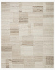 The Loloi Manfred Rug - Natural / Stone is a rectangular hand-knotted area rug featuring a patchwork design in beige and cream, with each section showing unique textures and patterns.