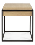 The Monolit Side Table - Oak and Black by Ethnicraft features a solid oak top and drawer with a minimalist black metal frame base.