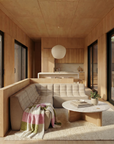 A modern living room with wood paneling, a light beige tufted sectional, a Wooden Stories Pivot Coffee Table | Round - Wood & Stone, a colorful throw blanket, a plant, large windows with natural light, and the kitchen visible in the background.