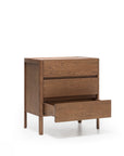 The Wooden Stories Nell Tall Dresser is featured here with its bottom drawer open and the top two drawers closed, highlighting its natural wooden finish. As part of the Danish Collection, this dresser offers stylish and functional bedroom storage with premium metal runners for smooth drawer operation and stands on four legs against a white background.
