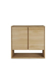 The Ethnicraft Nordic Sideboard - 2 door features a minimalistic design in solid oak, with two doors, an open bottom shelf, natural light wood finish, and clean lines—perfect for modern spaces.