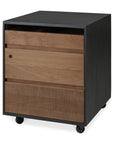 The Oscar Drawer Unit - Teak - Black by Ethnicraft features four casters, an open shelf, a lockable drawer, and a textured solid teak-front drawer for modern storage.