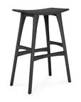 The Osso Barstool - Black by Ethnicraft features a modern black-stained solid oak design with a gently curved seat, four splayed legs, and two crossbars for support.