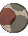 The Overlapping Dots Tray - Round / Large by Ethnicraft features abstract shapes in earthy olive green, beige, and rust red tones with translucent silhouettes, all accented by a dark rim from the Ethnicraft Tray Collection.
