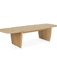 The Ethnicraft PI Coffee Table is crafted from solid oak with a light finish, rounded edges, and supported by two wide, flat panel legs.