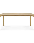 The PI Dining Table - Oak by Ethnicraft features a minimalist, modern design with rounded edges and legs, crafted in solid oak. It is shown against a plain white background.