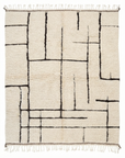 The SOBU Pasha Moroccan Rug is a rectangular cream-colored rug with black geometric lines and fringes on the top and bottom edges.