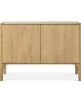 The Ethnicraft Pi Sideboard - 2 door features a minimalist design in solid oak, smooth hardwax oil finish, rounded edges, and stands on four legs.