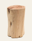 The Jupiter Side Table - Cedar by SOBU is crafted from a single natural cedar trunk, showcasing a light-toned surface with visible grain, knots, and an organic, uneven shape.