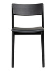 The Poise Dining Chair in Black Oak with Leather by Wooden Stories, featuring elegant Danish lines and a contoured seat, is shown from the front against a white background.