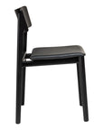 Side view of the Poise Dining Chair | Black Oak with Leather by Wooden Stories, a modern chair featuring a straight backrest and cushioned leather seat, set against a white background.