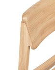 Close-up of the Poise Dining Chair | Light Oak by Wooden Stories, showcasing its backrest’s smooth, rounded edges, clean minimalist design, and visible wood grain.