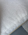Close-up of SOBU’s Woody Sofa (One Arm) featuring off-white natural kapok cushions and a white ash wooden base, shown with a woven rug and gray floor—a refined example of sustainable sofa style.