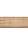 The Ethnicraft Shadow Sideboard - 5 door features minimalist design in European oak with an oiled finish, clean lines, smooth surfaces, and no visible handles or decoration—reflecting Ethnicraft’s signature style.
