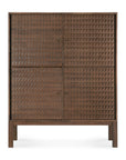The Sono Cupboard by Ethnicraft is a solid teak cabinet with four doors, each featuring hand-carved, textured geometric panels. Standing on short legs, it offers a modern, minimalist look.