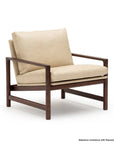 A contemporary Troubadour Lounge Chair from Wooden Stories, featuring Alabama Limestone leather cushions and a sturdy Espresso Oak frame with wide armrests and a minimalist design.