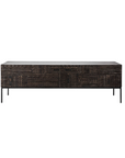 The Ethnicraft Tabwa TV Cupboard - 94 is a long, rectangular sideboard with slim black legs and hand-carved linear geometric patterns on dark wooden fronts, inspired by signature Ethnicraft designs.