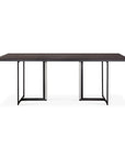 The Ethnicraft Tacet Dining Table features a modern rectangular silhouette with a dark teak top and black metal U-shaped geometric legs, displayed against a white background.