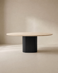 The Wooden Stories Tathra Round Dining Table features a stone top and a thick black cylindrical base, showcased against a plain beige background.
