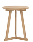 The Ethnicraft Tripod Side Table - Oak is a round, light wood piece made from European oak, with three angled legs joined at the base, showcasing the brand’s signature simple and modern design.