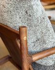 Close-up of the SOBU Viking Lounge Chair - Walnut, showcasing its solid walnut frame with a smooth finish, brass accent, and textured light gray upholstery.