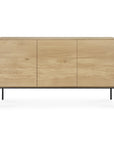 The Ethnicraft Whitebird Sideboard - 3 door is crafted in solid oak with a light natural finish, featuring three flat doors and slim black metal legs, photographed against a plain white background.