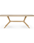 The Ethnicraft X Dining Table - Oak features a modern design with European oak, a light finish, rounded corners, and intersecting angled legs beneath the tabletop, highlighting the brand’s signature quality and minimalist style.