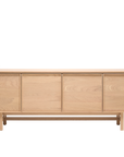 The Wooden Stories Yorke Sideboard features a minimalist Scandinavian-inspired design with four flat cabinet doors, crafted from light solid oak, and is shown against a plain white background.