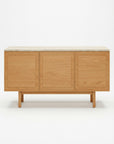 The Wooden Stories Yorke Sideboard with Stone Top showcases Danish-inspired lines, three spacious flat-panel doors, four short legs, and a light stone surface, all presented against a plain white background.