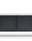 The Wooden Stories Yorke Sideboard with Stone Top features Danish-inspired black wood, four cabinet doors, a sleek white stone top, and slim black legs, shown against a white background.