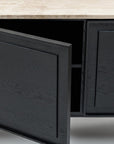 A close-up of the Wooden Stories Yorke Sideboard with Stone Top shows its Danish lines, light stone surface, and dark wood doors; one door is partly open, revealing the empty interior.