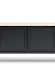 The Yorke Sideboard with Stone Top by Wooden Stories features four black paneled doors, a light-colored stone top, and slim black legs, showcasing modern Danish lines.