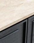 Close-up of the Wooden Stories Yorke Sideboard with Stone Top: light beige stone surface atop cabinets in dark gray textured grain, with minimalist handles and a subtle paneled motif.