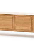 The Yorke Sideboard with Stone Top by Wooden Stories features four flat panel doors in a light oak finish, a white marble top, and Danish-inspired design with short square legs.