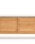 The Wooden Stories Yorke Sideboard with Stone Top features four rectangular cabinet doors, clean Danish lines, minimalist design in light wood, and stands on short legs.
