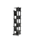The Ethnicraft Abstract Column is a tall, modern black bookshelf with an open, asymmetrical design and multiple square shelves stacked vertically in a geometric pattern.