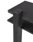 Close-up of the corner of Ethnicraft’s Abstract Console, a black wooden table with thick rectangular legs and a secondary shelf, showcasing a modern de Stijl-inspired design.