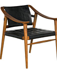 The Garibaldi Chair by Noir Trading Inc. features a modern teak frame, curved design, black tufted leather seat and backrest, slender angled legs, and a minimalist mid-century style.