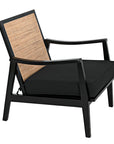 The Lichtenstein Chair by Noir Trading Inc. features a black Sungkai/Mindi solid wood frame, woven cane backrest, and thick black cushioned seat. Its minimalist design is slightly angled for added comfort.