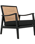 The Lichtenstein Chair by Noir Trading Inc. features a black Sungkai/Mindi solid wood frame, angled armrests, black seat and back cushions, and a woven rattan backrest panel.