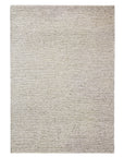The Andorra Rug - Terrazzo by Armadillo&Co is a rectangular, light beige Fair Trade wool rug with a solid, textured surface and no visible patterns or borders, shown against a white background.